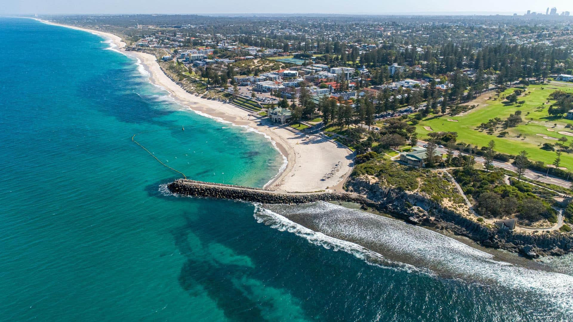 Cottesloe Beach from the air, with the Perth city towers on the horizon